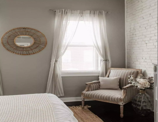 Brick Accent Bedroom with Striped Chair