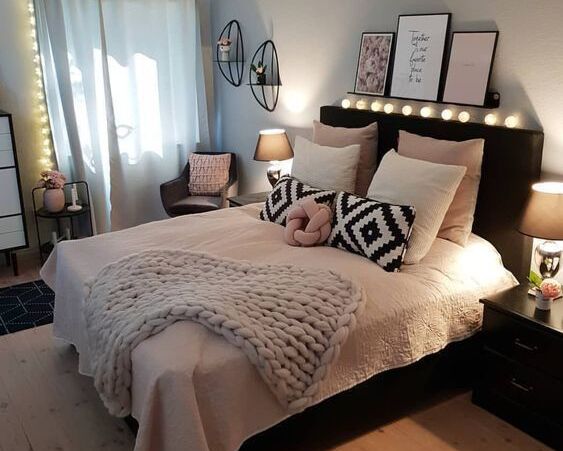 Black Bed with Soft Pink and Beige Bedding
