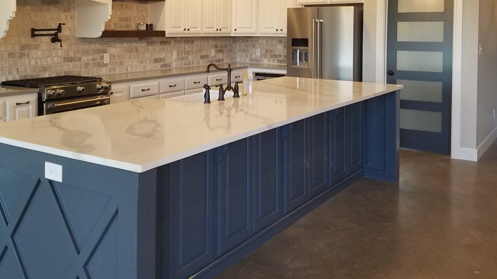 Kitchen with I-Shaped Concrete Floor and Raised Panel Cabinets